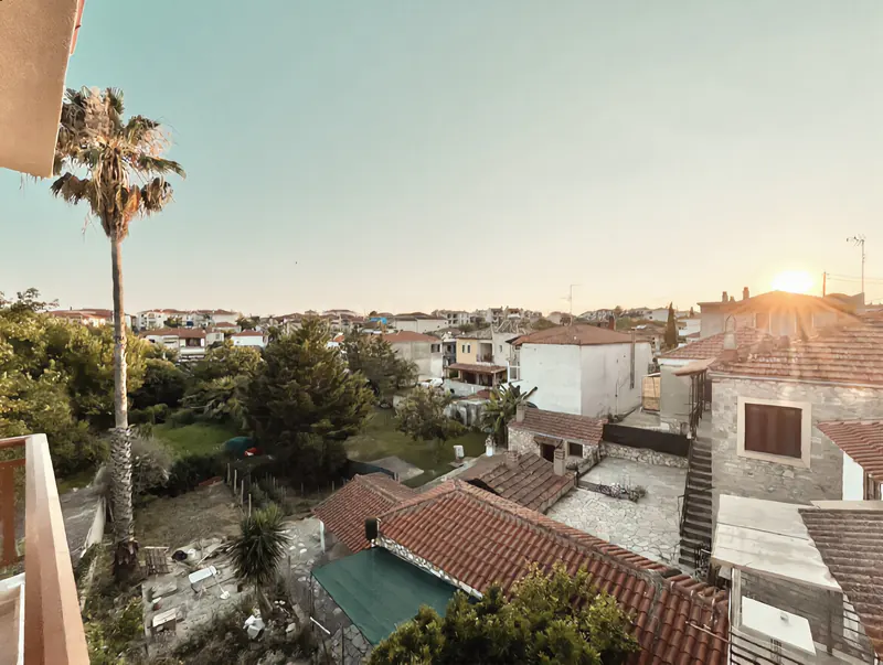Sunset over the tiled roofs of Afytos seen from InLofts